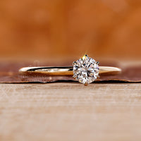 Solitaire round diamond ring six claw prong set.
