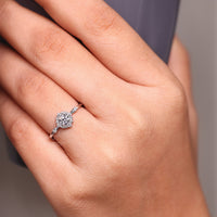 Round cut ring cluster halo four prong diamond setting.