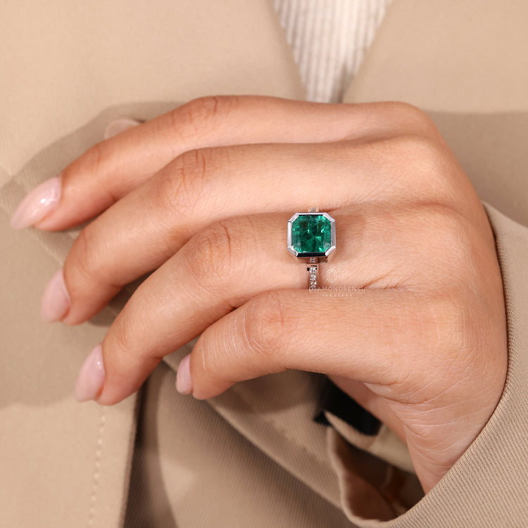 Asscher gemstone ring emerald bezel diamond band.