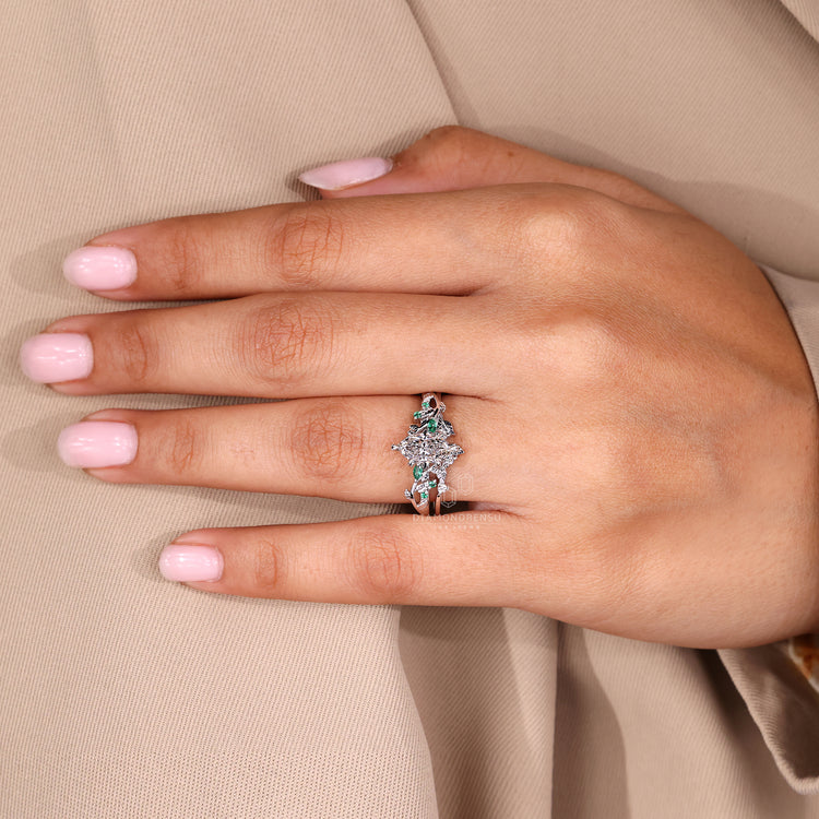 Dutch marquise ring with green emerald cluster details.