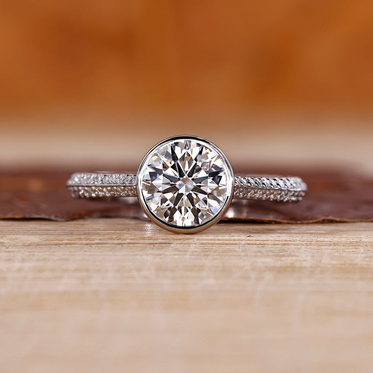 Bezel diamond ring with round centre diamond.