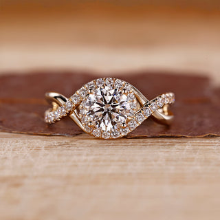 Round cut diamond ring halo twisted shank four prong.