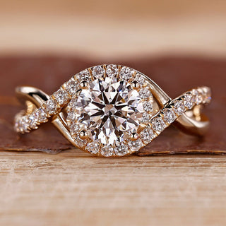 Round cut diamond ring halo twisted shank four prong.