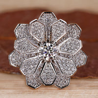 Vintage diamond cluster ring with round centre diamond.
