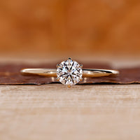 Round cut diamond ring solitaire six claw prong set.