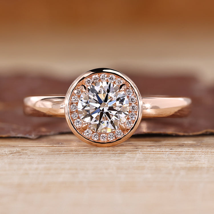Round diamond ring halo bezel four claw prong setting.