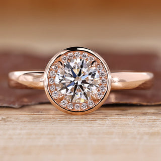 Round diamond ring halo bezel four claw prong setting.