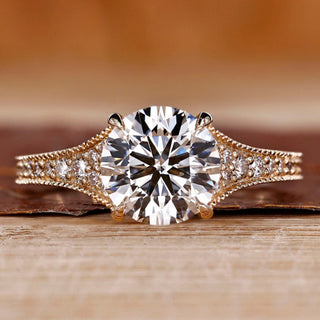 Round cut diamond ring tapered pave milgrain bridge set.