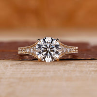Round cut diamond ring tapered pave milgrain bridge set.