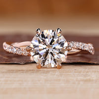 Round cut diamond ring twisted pave six claw prong.