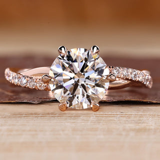 Round cut diamond ring twisted pave six claw prong.