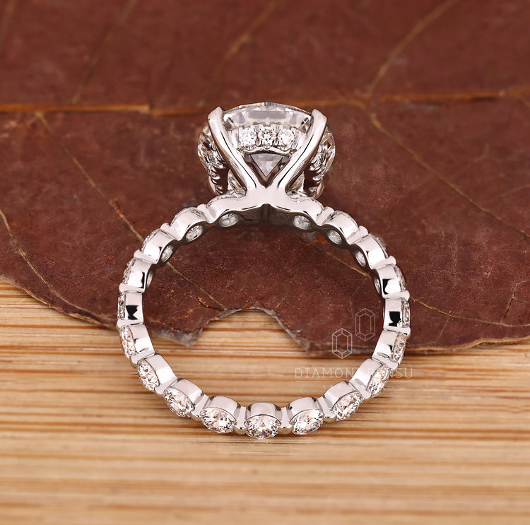 Blue oval diamond ring with four claw prong setting.