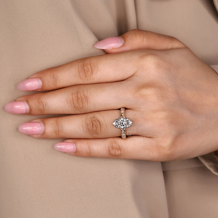 Marquise cut ring milgrain four claw prong setting.