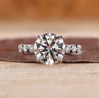Three stone ring with blue oval center diamond.