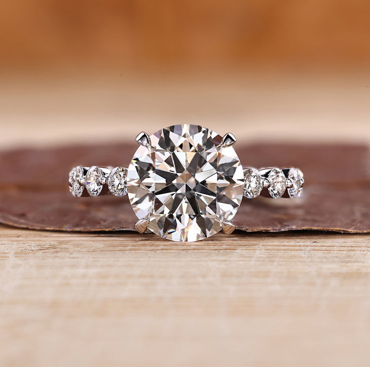 Three stone ring with blue oval center diamond.