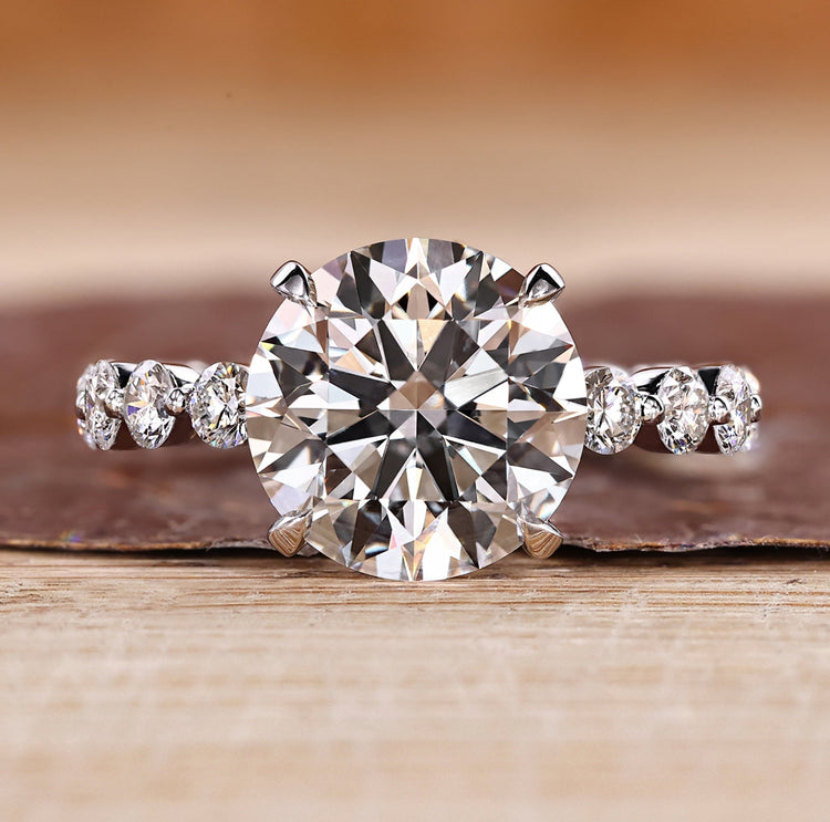 Three stone ring with blue oval center diamond.