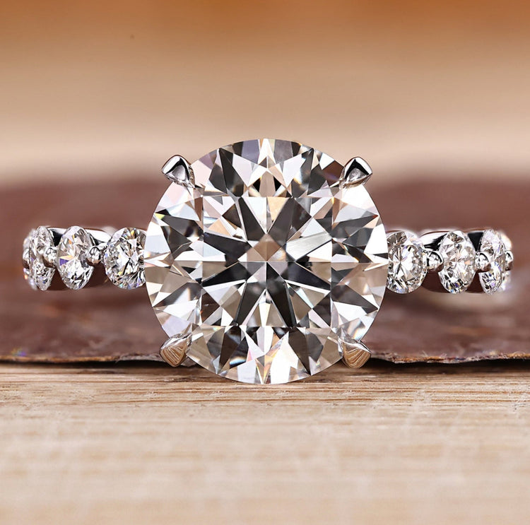 Three stone ring with blue oval center diamond.