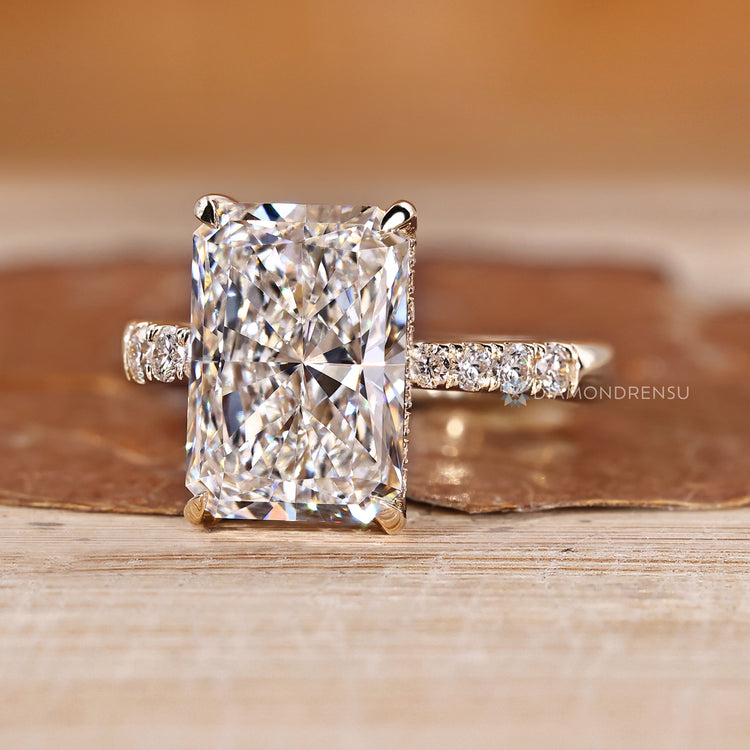 Lab grown radiant diamond ring with round diamond pave.