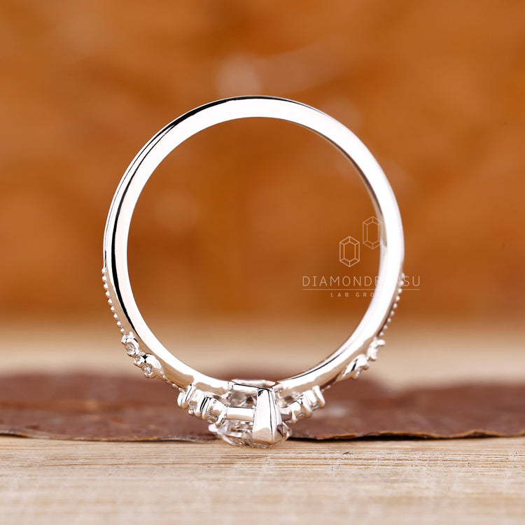 Marquise diamond ring round side stones cluster.