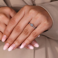 Round cut diamond ring four prong tapered shank.