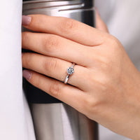 Round cut ring solitaire six claw pinched shank.