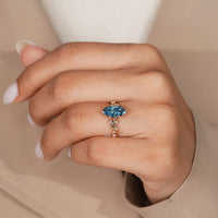 Nature inspired marquise diamond ring with blue diamond.