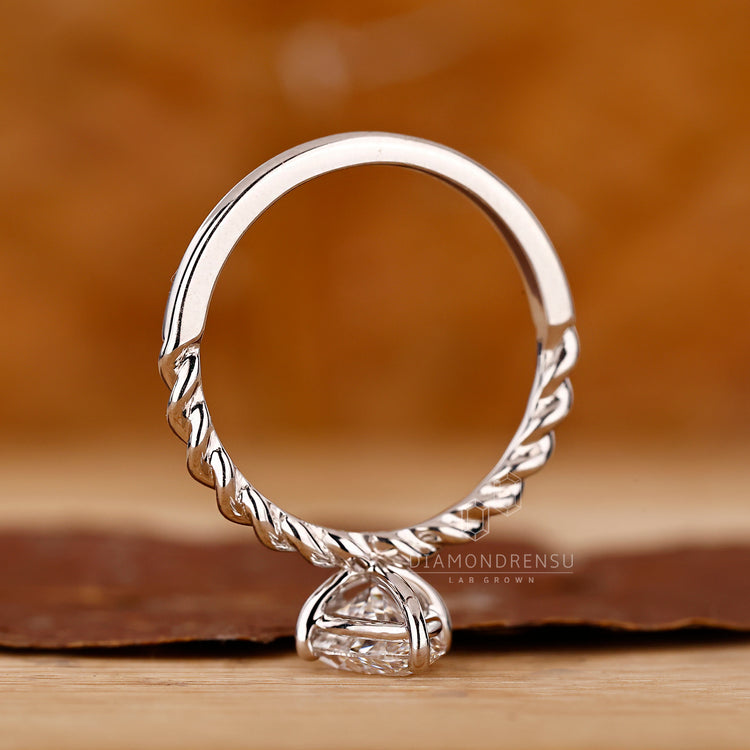 Marquise ring compass prong twisted pave style.