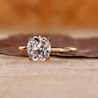 Solitaire cushion old cut ring four claw prong setting.