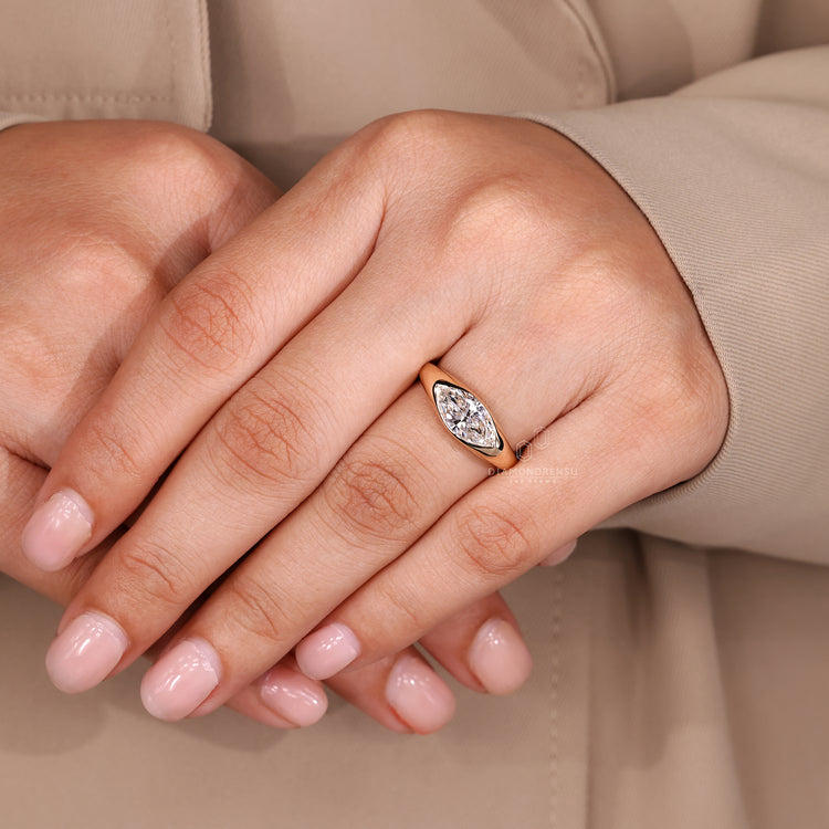 Tapered shank marquise diamond solitaire ring.