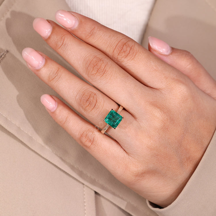 Emerald gemstone ring cathedral tapered shank design.