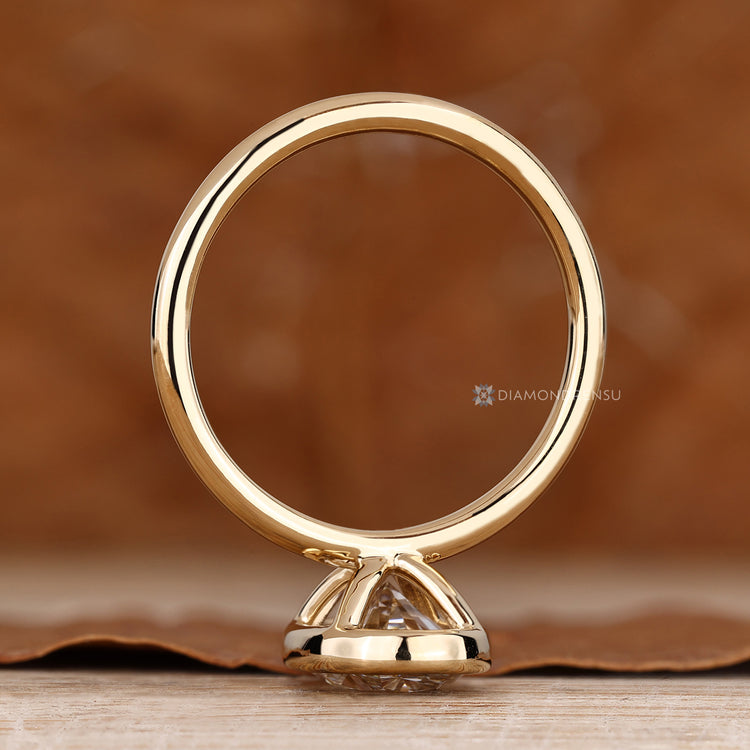 Oval cut diamond ring with a classic bezel setting.
