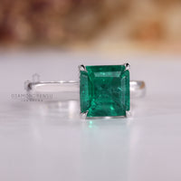 Asscher cut ring emerald cathedral prong style set.