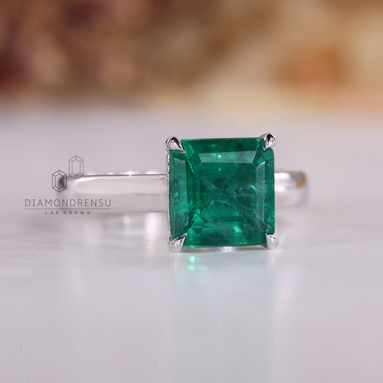 Asscher cut ring emerald cathedral prong style set.
