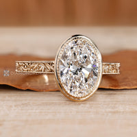 Oval cut diamond ring with cathedral setting.
