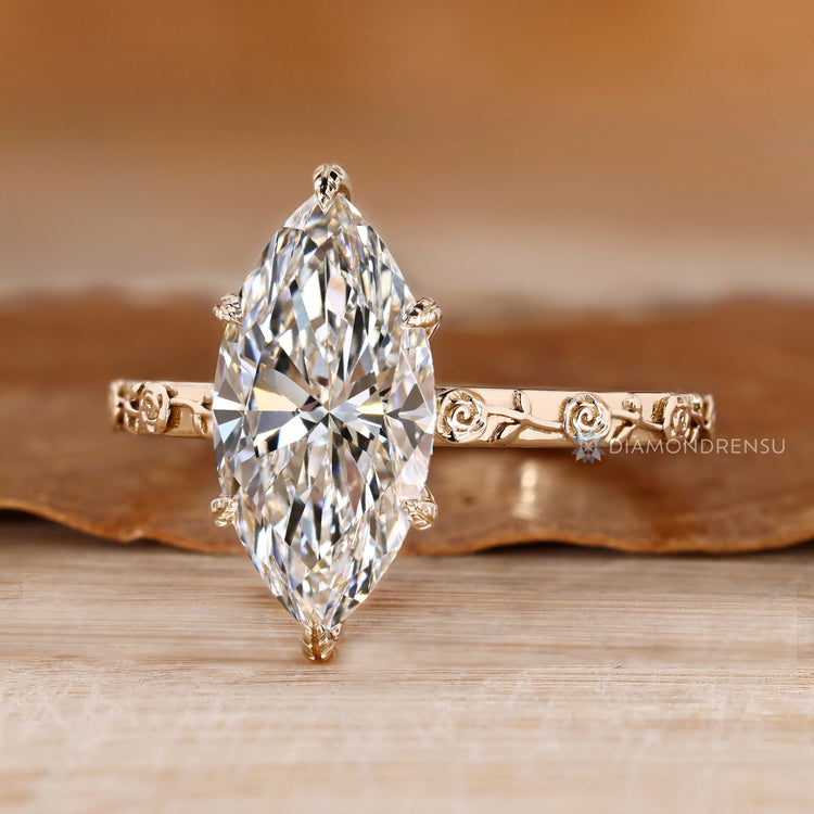 Marquise diamond ring with Art Deco floral details.