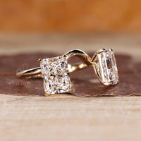 Curved style radiant cut diamond ring with claw prongs.