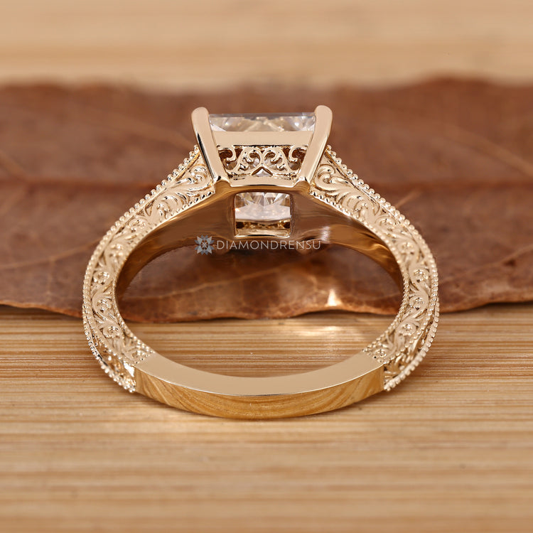 Princess cut diamond ring with round diamond accents.