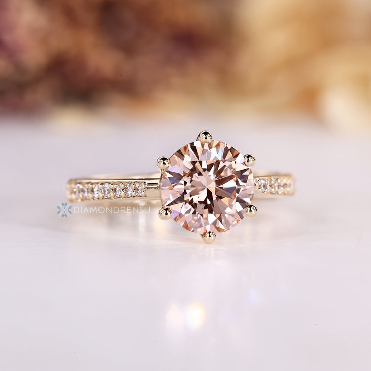 Round diamond ring with tapered shank.
