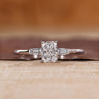 Radiant cut diamond ring baguette three stone cathedral.