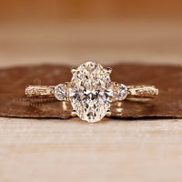 Oval cut diamond ring three stone art deco tapered shank.