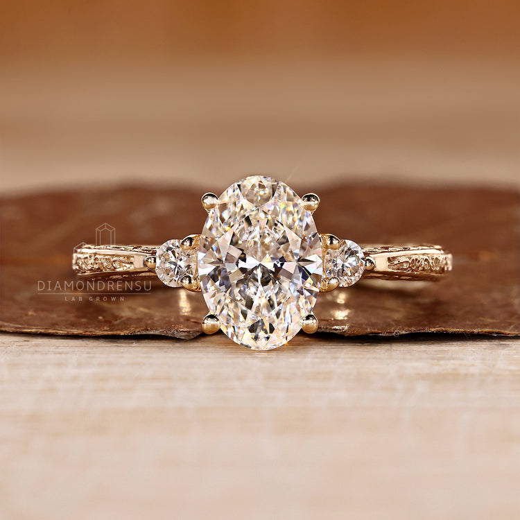 Oval cut diamond ring three stone art deco tapered shank.