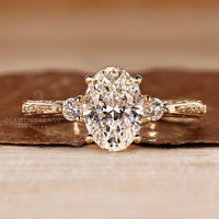 Oval cut diamond ring three stone art deco tapered shank.