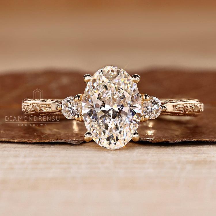 Oval cut diamond ring three stone art deco tapered shank.