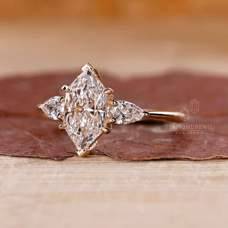 Lab grown marquise diamond ring three stone style.