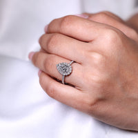Pear cut ring halo pave three claw prong setting.