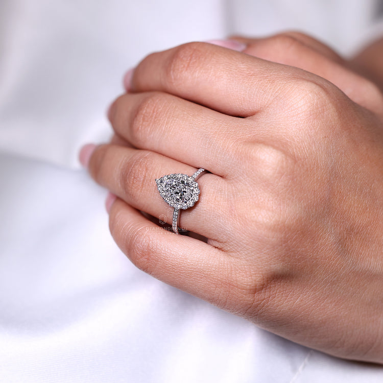 Pear cut ring halo pave three claw prong setting.
