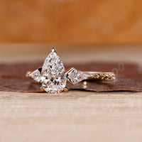 Art deco pear diamond ring kite side stones design.