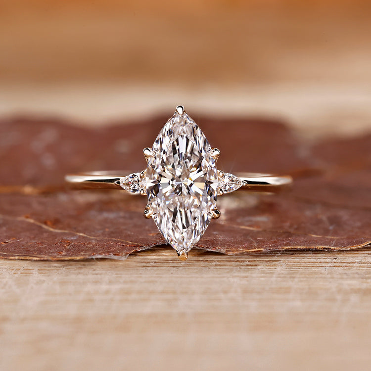 Marquise diamond ring pear side stones three stone set.