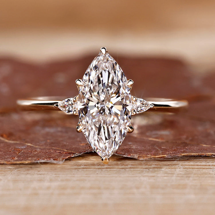 Marquise diamond ring pear side stones three stone set.