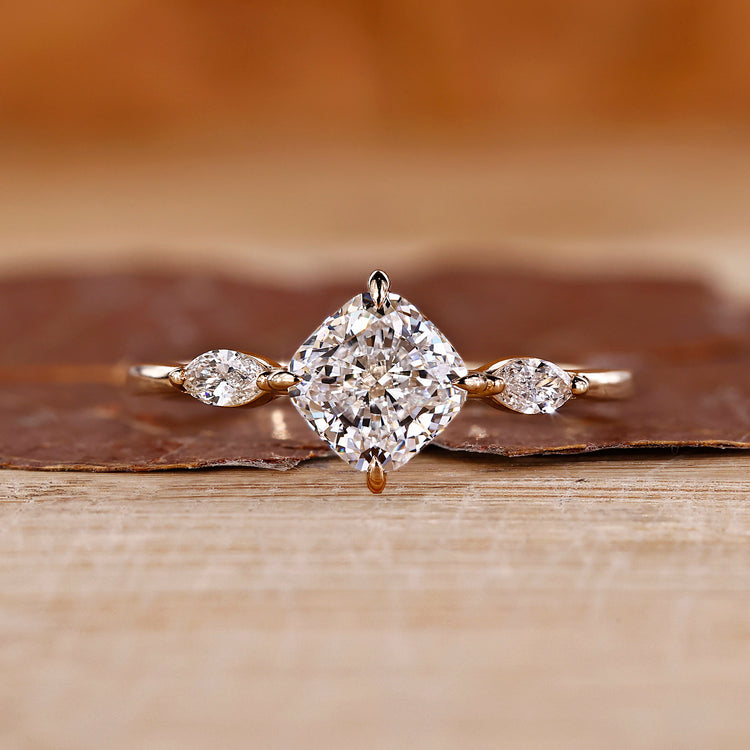 Cushion cut diamond ring marquise side stones three stone.